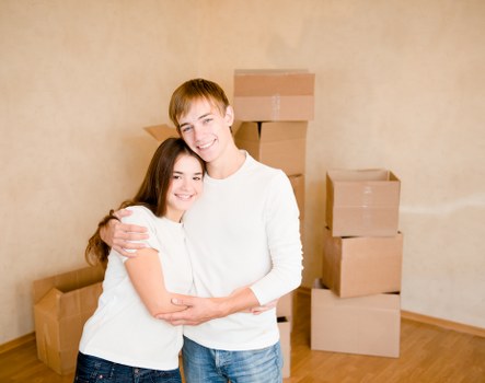 Prepared moving boxes and furniture in a residential hallway
