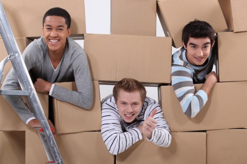 Workers using safe lifting techniques during a removals job