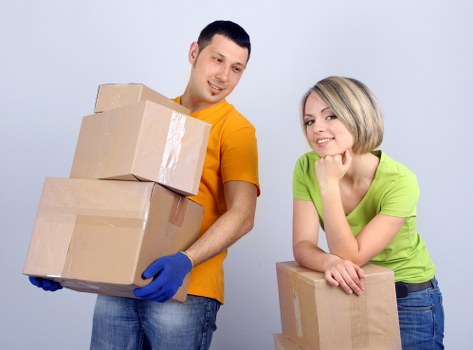 Packed office items and moving trolleys during a business relocation